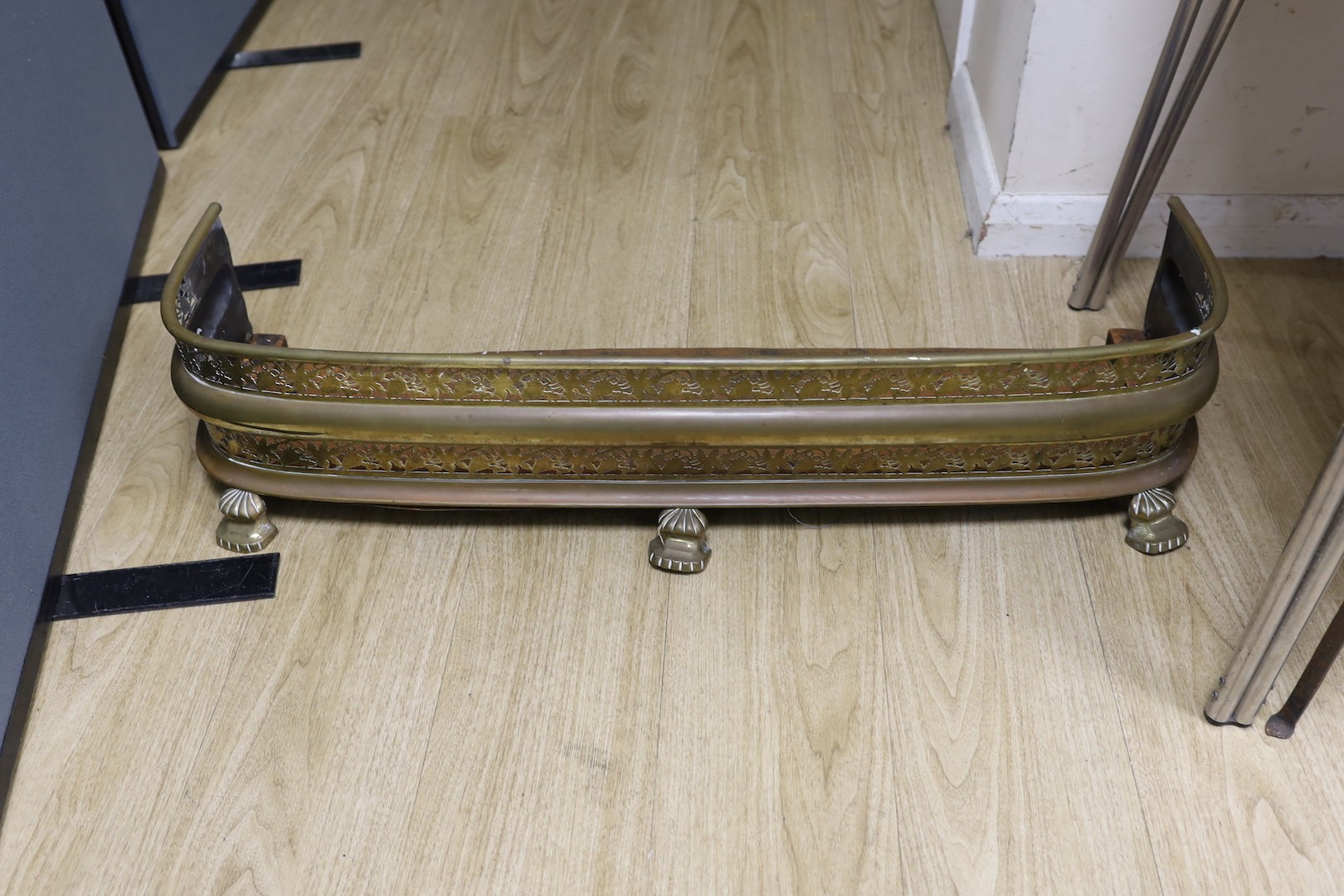 A copper kettle and trivet stand, a brass coal scuttle and a fender, Trivet 33 cms high.